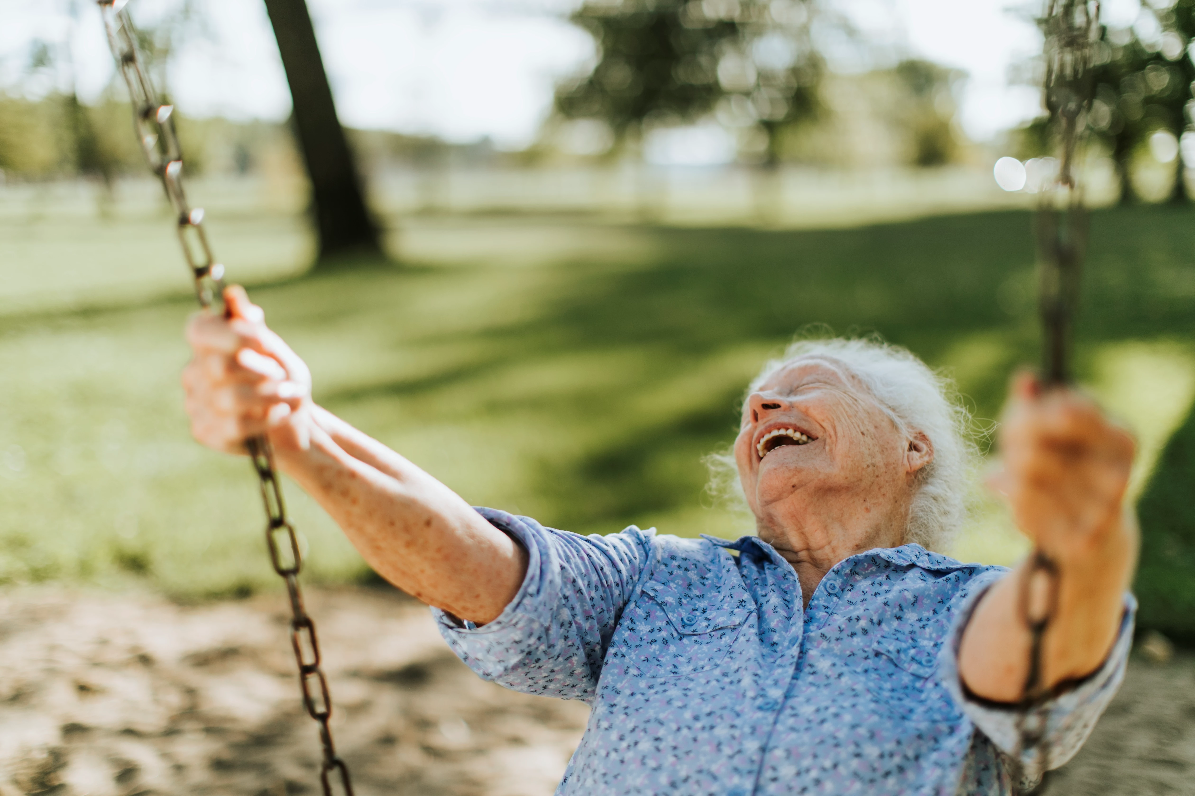 Happy older woman on swing